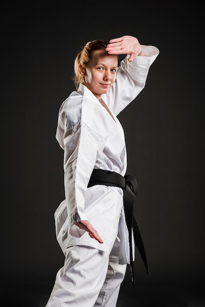 Free photo caucasian karate woman posing medium shot