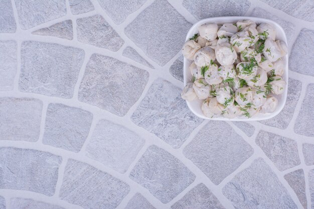 Caucasian khinkal stuffings in bowl with minced herbs on top.