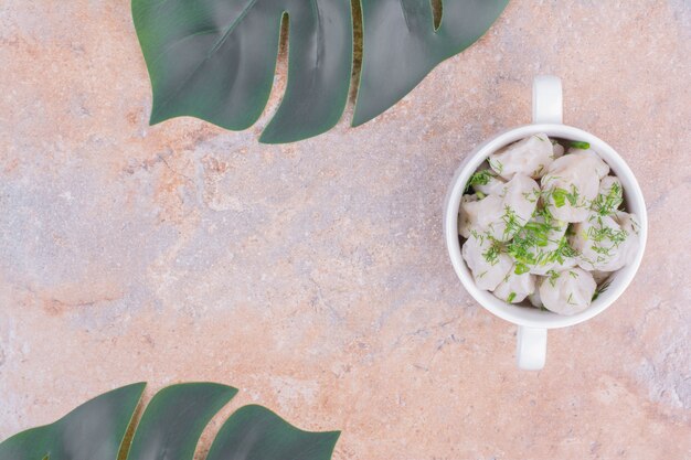 Free photo caucasian khinkali dough in a white plate with herbs and spices