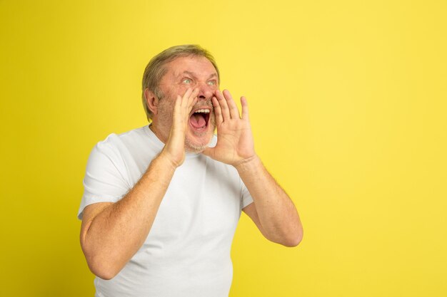 Caucasian man Calling, screaming isolated on yellow