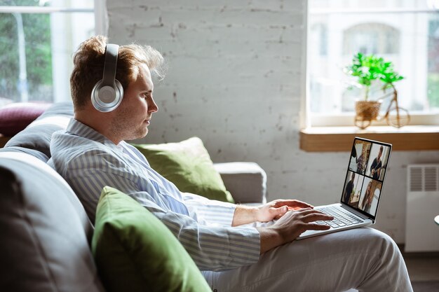 Caucasian man during online concert at home isolated and quarantined,