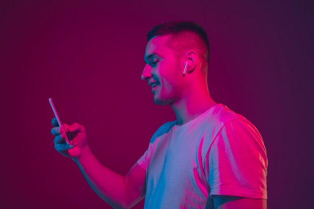Caucasian man's portrait isolated  in neon light