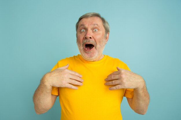 Caucasian man Showing on himself, astonished isolated on blue