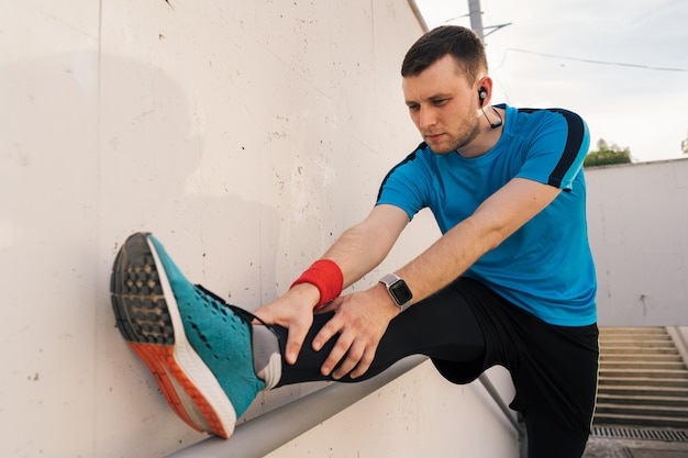 Caucasian man stretching city workout