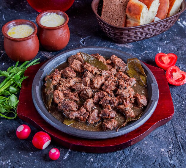 Caucasian meat govurma with herbs and tomatoes