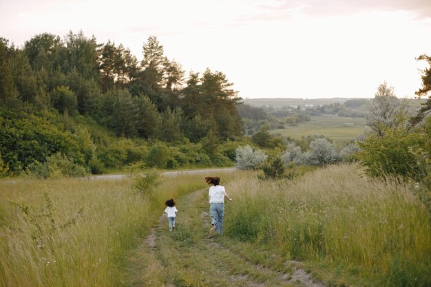 Caucasian mother and her african american daughter running together