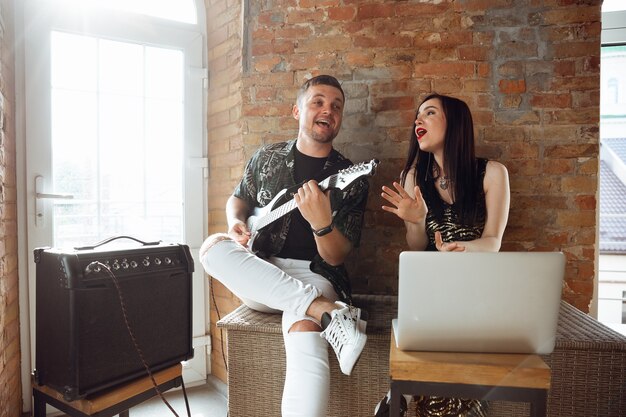 Caucasian musicians during online concert at home insulated and quarantined, cheerful and happy