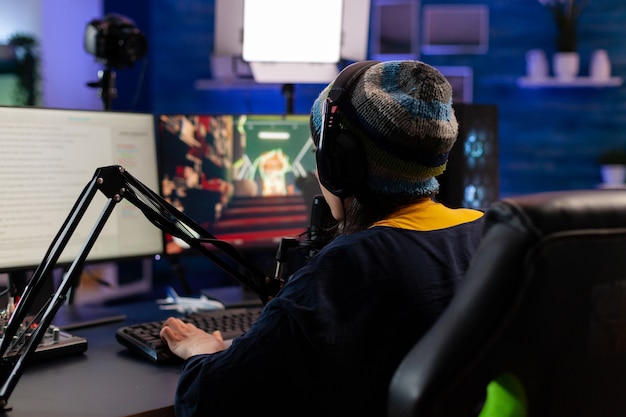 Free photo caucasian player wearing headphones talking with other players while playing professional shooter games in online tournament. gamer making online videogames with new graphics on powerful computer