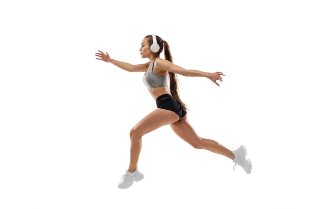 Free photo caucasian professional female runner, athlete training isolated on white studio