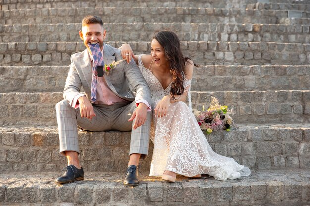 Caucasian romantic young couple celebrating marriage in city.