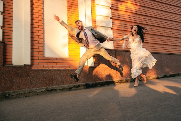 Caucasian romantic young couple celebrating marriage in city.