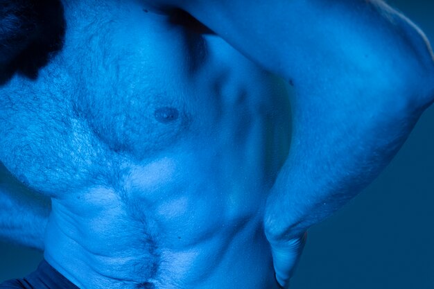 Caucasian shirtless man in blue tones