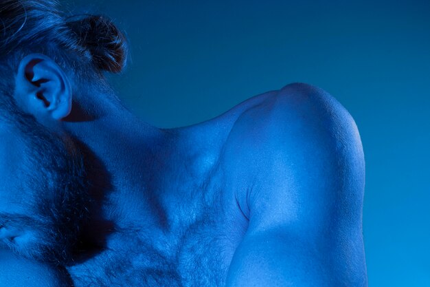 Caucasian shirtless man in blue tones