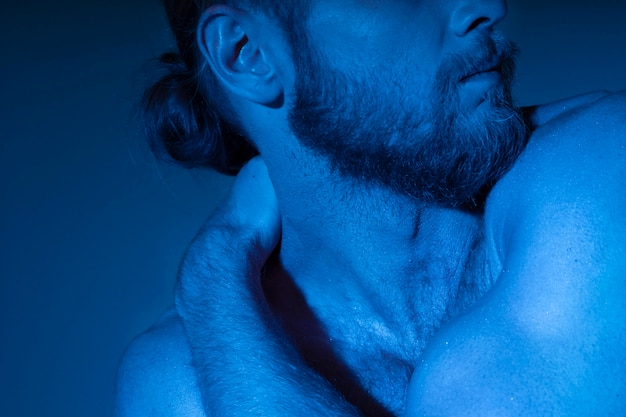 Free photo caucasian shirtless man in blue tones