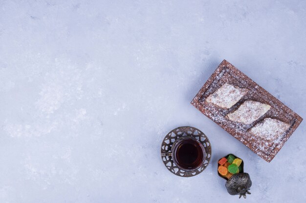 Caucasian tea set with metallic tea glass and pastry platter, top view