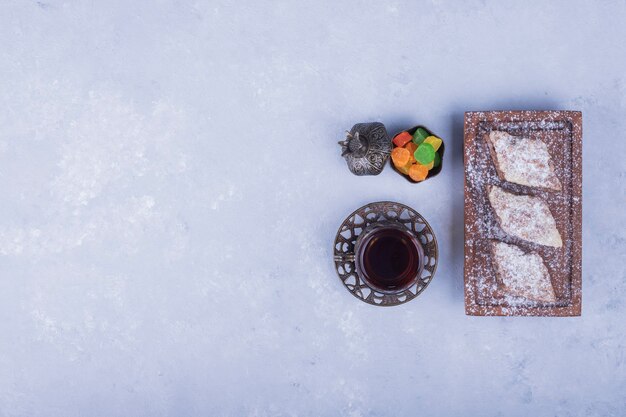 Caucasian tea set with metallic tea glass and pastry platter, top view