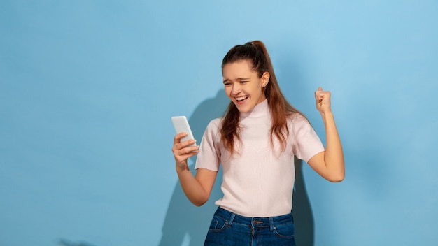 Caucasian teen girl portrait isolated on blue