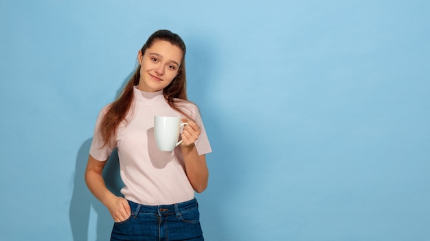 Caucasian teen girl portrait isolated on blue