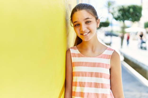 Free photo caucasian teenager girl smiling happy standing at the city