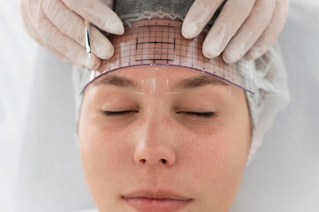 Caucasian woman going through a microblading procedure