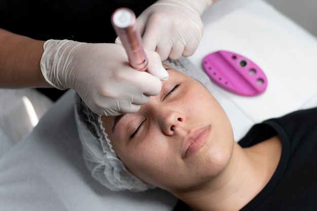 Caucasian woman going through a microblading treatment