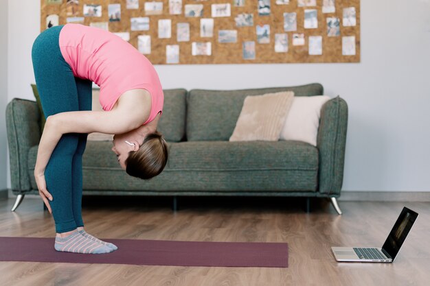 Caucasian woman practicing yoga at home