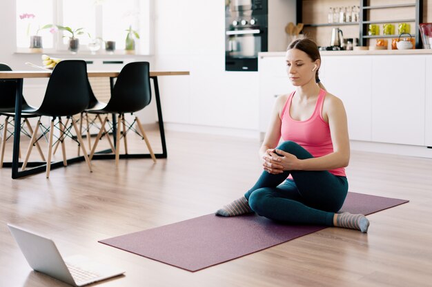 Caucasian woman practicing yoga at home