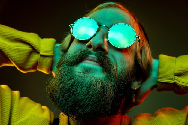 Caucasian woman's portrait on gradient  space in neon light