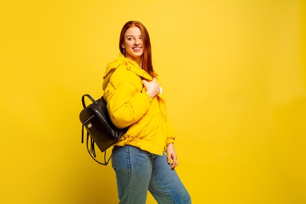 Free photo caucasian woman's portrait isolated on yellow studio background, follower be like