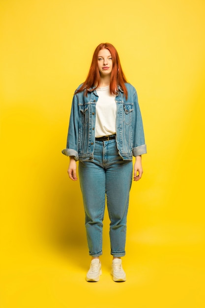 Free photo caucasian woman's portrait isolated on yellow studio