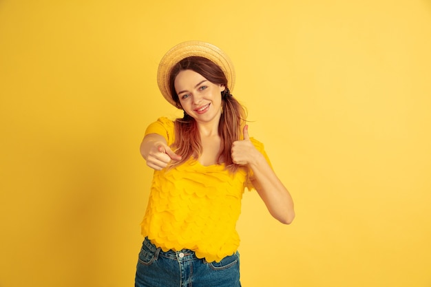 Caucasian woman's portrait on yellow studio