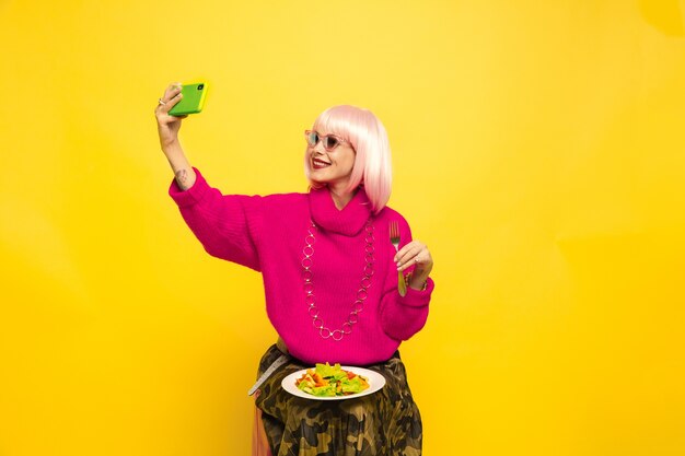 Caucasian woman's portrait on yellow