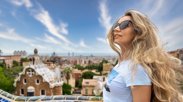 Caucasian woman in sunglasses with view of Barcelona on the background, Spain