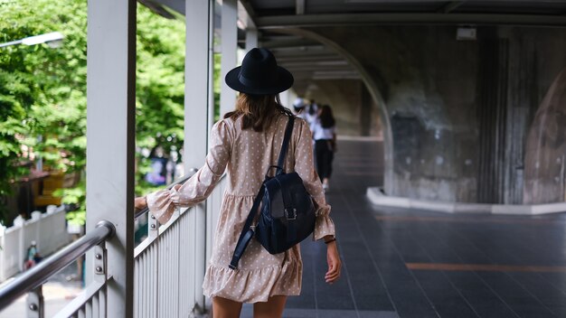 Caucasian woman walking on subway crossing in medical face mask while pandemia in Bangkok city.