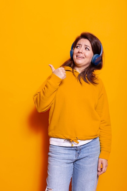 Caucasian woman wearing headphones to listen to song