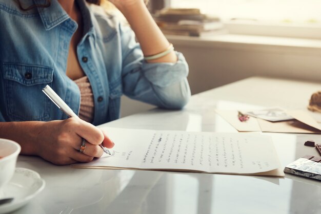 Caucasian woman writing a letter