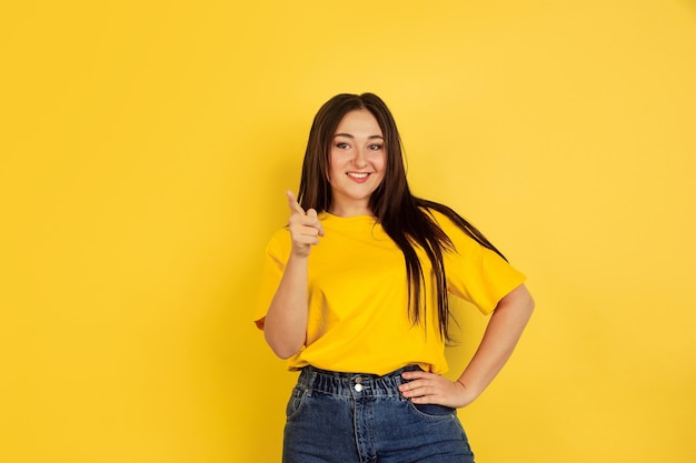 Caucasian womans portrait isolated on yellow wall