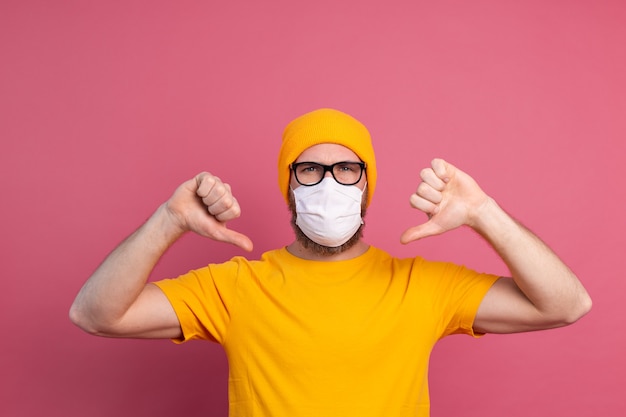 Caucasian young man in glasses with single use medical mask to prevent infection, respiratory disease such as flu