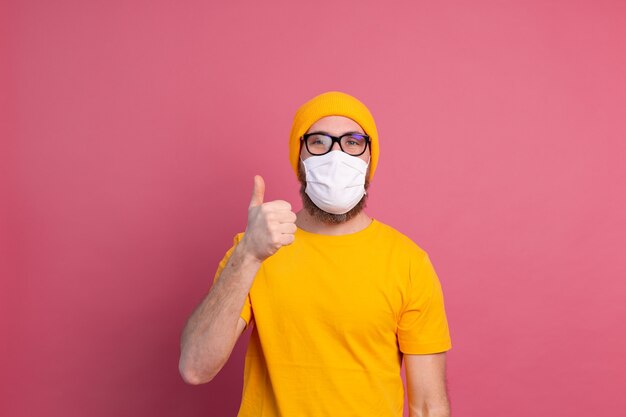 Caucasian young man in glasses with single use medical mask to prevent infection, respiratory disease such as flu