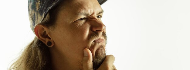 Caucasian young man's close up shot on studio background