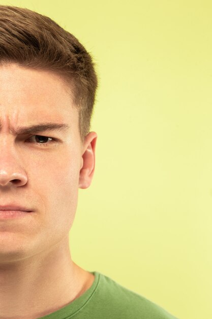 Caucasian young man's close up shot on studio