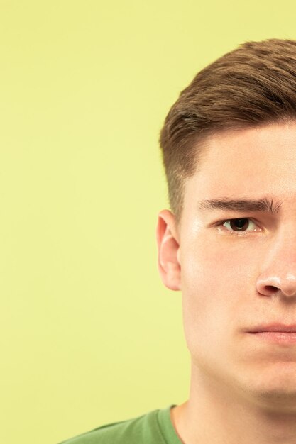 Caucasian young man's close up shot on studio