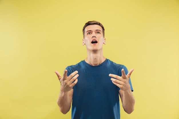 Caucasian young man's half-length portrait  Beautiful male model in blue shirt