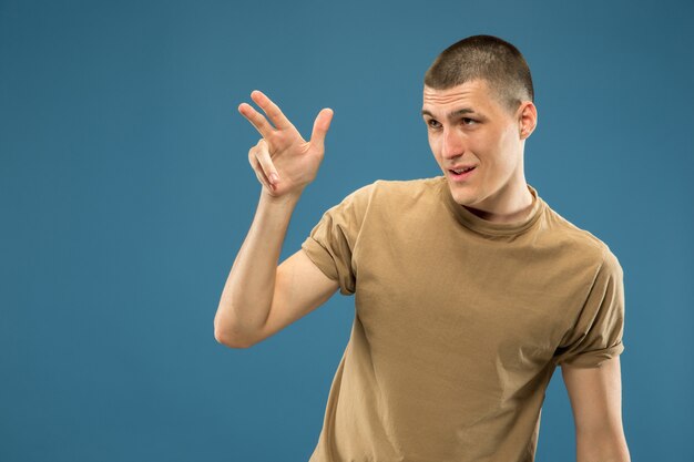 Caucasian young man's half-length portrait. Beautiful male model in shirt