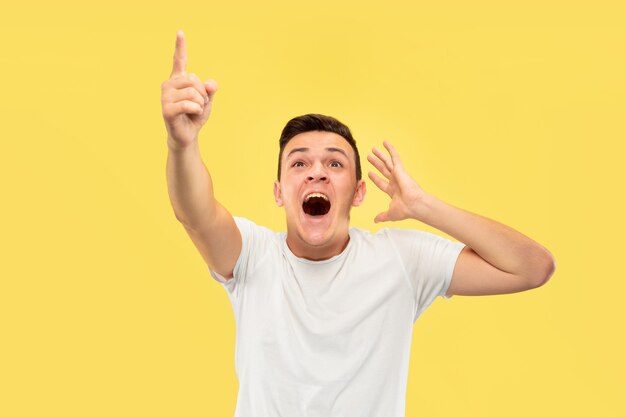 Caucasian young man's half-length portrait on yellow