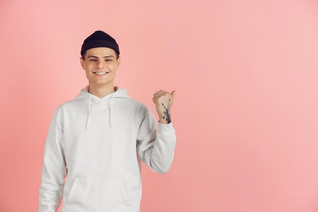 Caucasian young man's modern portrait on pink