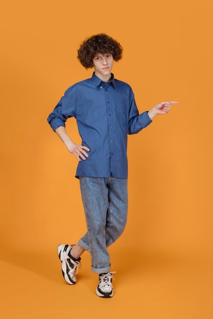 Caucasian young man's portrait isolated on yellow studio background with copyspace