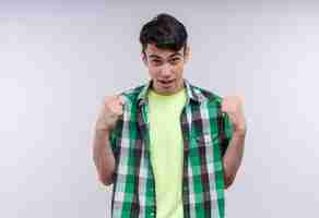 Free photo caucasian young man wearing green shirt doing strong gesture on isolated white wall