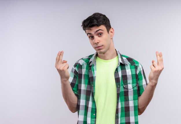 caucasian young man wearing green shirt showing two with both hands on isolated white wall