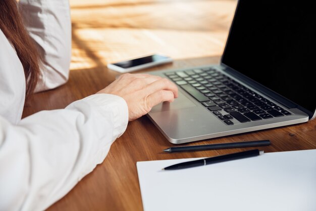 Caucasian young woman in business attire working in office